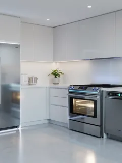 Modern kitchen with smart induction range, energy-efficient refrigerator, and smart dishwasher.
